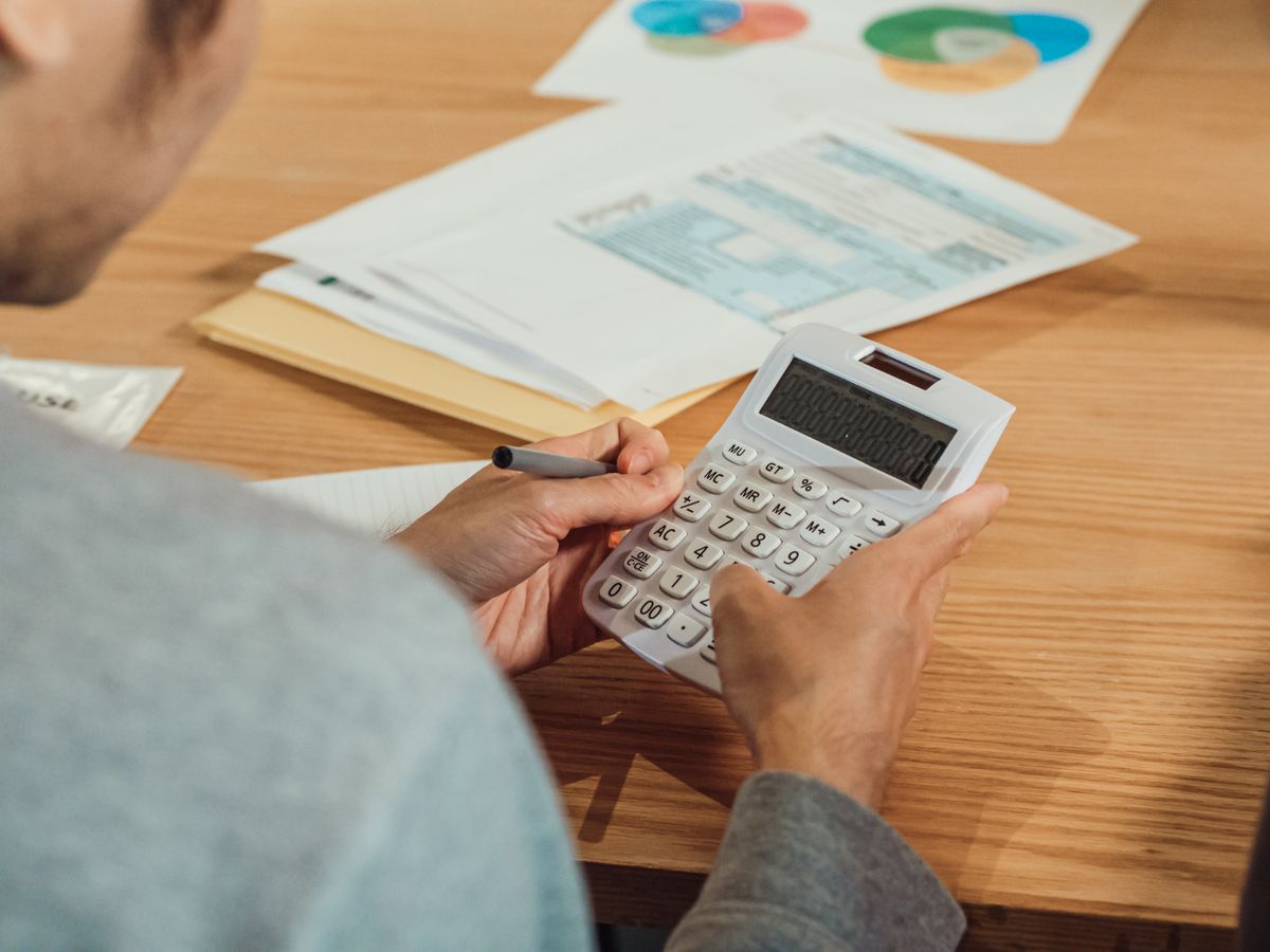 Reviewing financial paperwork with a calculator