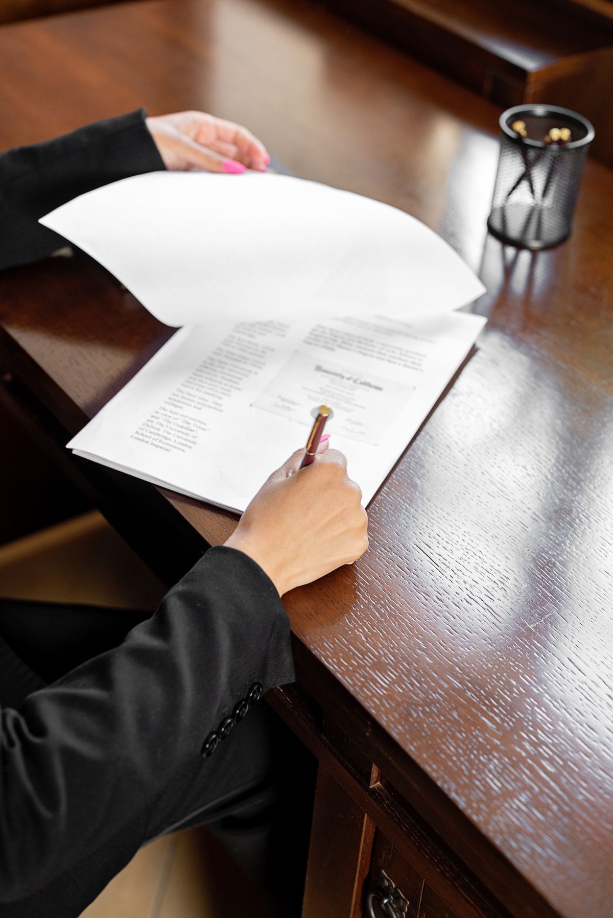 Reviewing a document with a pen at a desk